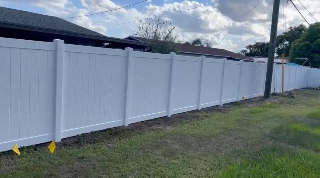 Long white vinyl privacy fence on a Central Florida lot